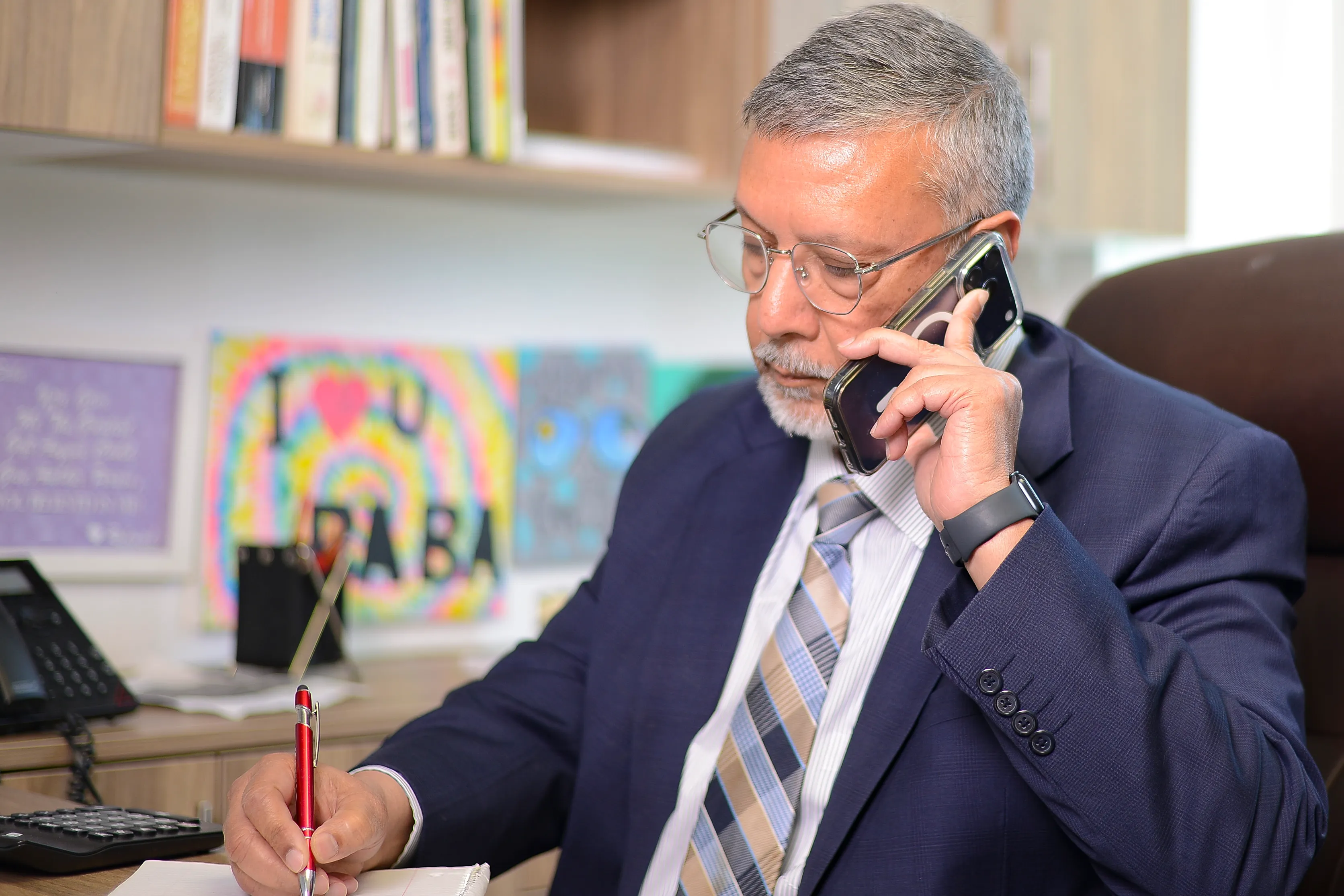 Irfan taking a client call at his desk
