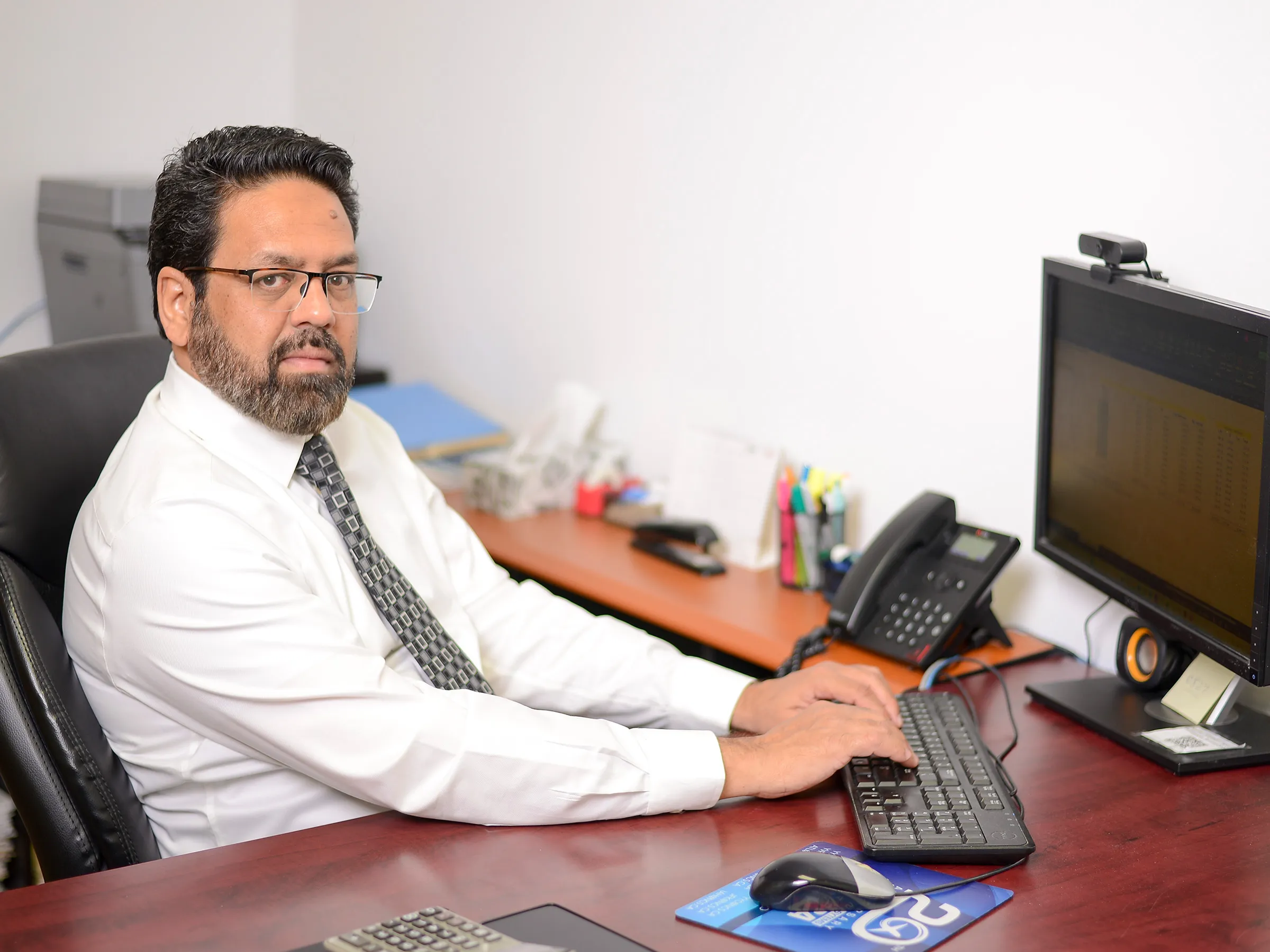 Rehan reviewing a corporate tax return at the Hawks office